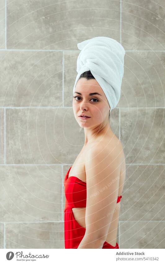 Young woman in head towel after shower bathroom sensual hygiene wall home portrait style young appearance routine wear female charming apartment feminine