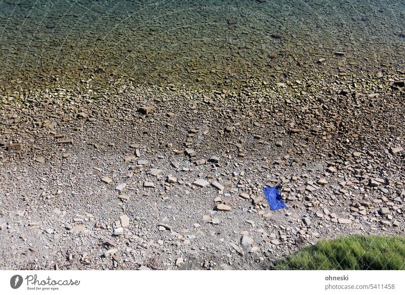 Blue towel on a lonely beach Towel Beach stones vacation Deserted Ocean Vacation & Travel Summer Exterior shot Water Relaxation coast Colour photo Tourism