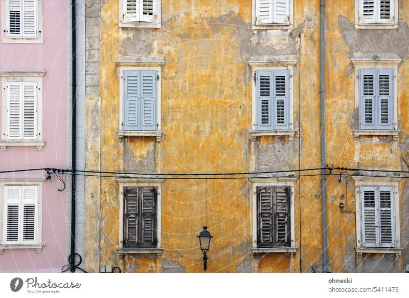 Old pink and yellow facade with chipped plaster Facade Architecture House (Residential Structure) Window Manmade structures Yellow Pink Lantern Old town Town