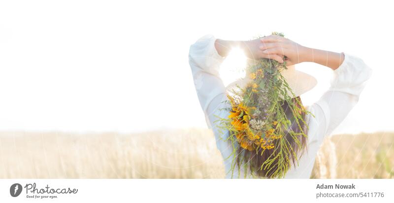 Alternative medicine, woman holds wildflowers, herbs. Banner, advertising space. herbaceous Hair Woman Copy area idyllically Flower care Copy Space Meadow