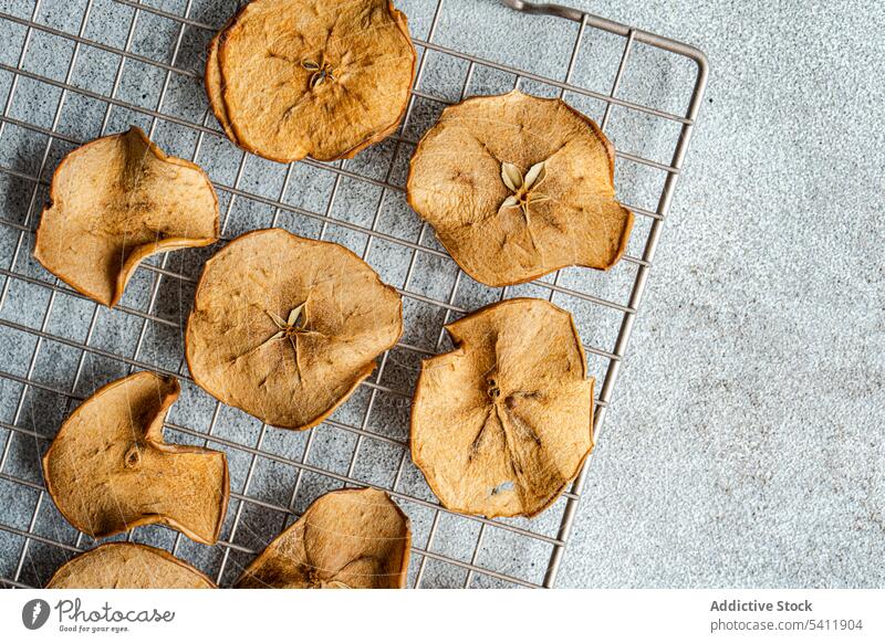 Slices of dried apples on oven tray slice fruit high angle from above blur blurred background many taste tasty yummy delicious healthy nutrient nutrition
