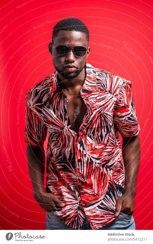Stylish black man in sunglasses tropical shirt trendy fashion confident outfit appearance portrait style model male african american serious individuality
