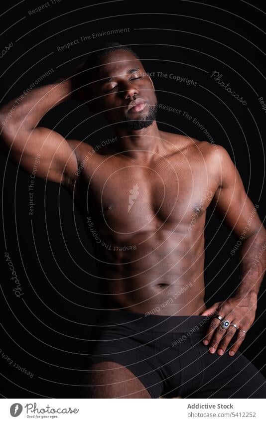 Serious black man with naked torso sportsman athlete muscular shirtless portrait eyes closed macho confident masculine strong male ethnic muscle model young fit