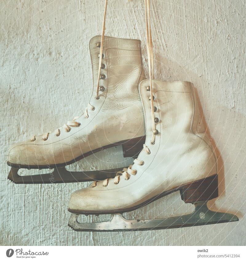 Winter boots Ice-skates heel shoes Suspended dangling Winter sports Blade Leather Figure skating Retro Wall (building) Sports Training Footwear Colour photo