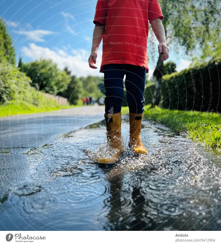 Child running through puddle with rubber boots in sunshine Puddle Jump Rubber boots Water Inject Sun Summer