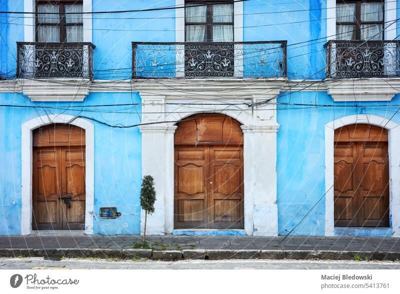 Street view of an old building facade, architecture background, Riobamba, Ecuador. wall blue window door travel street city town colonial house south America