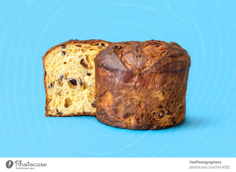 Homemade panettone isolated on a blue background. Sliced panettone baked bread bright brown cake celebration christmas close-up color concept copy space cuisine