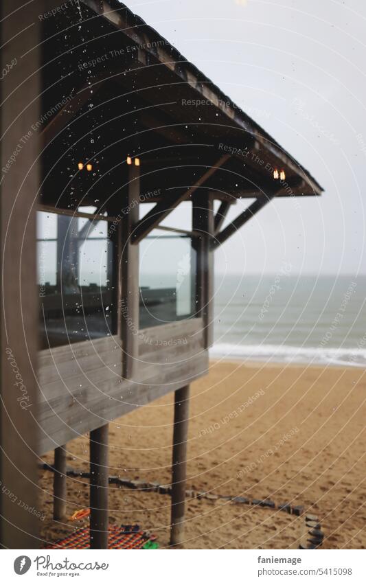 Regen auf dem Dach des Strandpavillons regnerisch Unwetter Mistwetter Regentropfen Nordsee Nordseewetter Kühle grau Wolkenbruch Restaurant Lichter Spiegelung