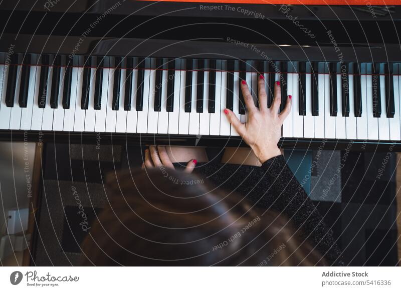 Top view of cropped hands playing the piano top view woman musician elegant room pianist instrument keyboard art sound performance melody classical harmony