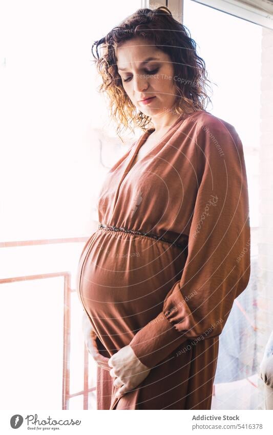 Attractive pregnant woman near balcony in room window attractive young curly hair beautiful closed eyes female belly lifestyle relax casual leisure home elegant
