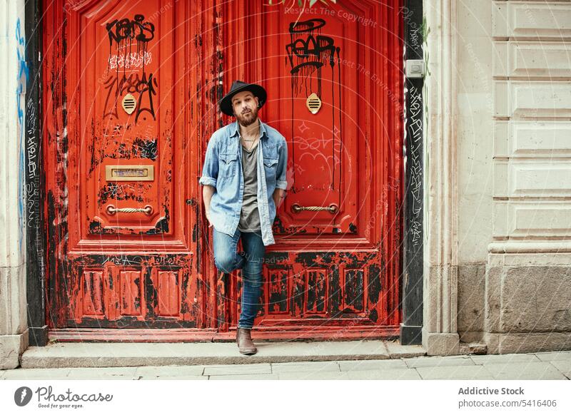 Handsome man standing leaning foot into doors handsome thoughtful bearded adult model young confident male casual looking stylish leisure stubble lifestyle