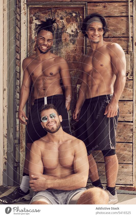 Muscular multi ethnic guys near shabby building men muscular confident gym multiracial young shirtless strong males hispanic black african american diversity