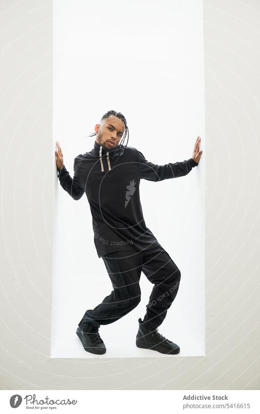 Dancing ethnic male with braids man african american hip-hop dancer rap braided hair young person handsome active trendy stylish energetic serious bearded cool