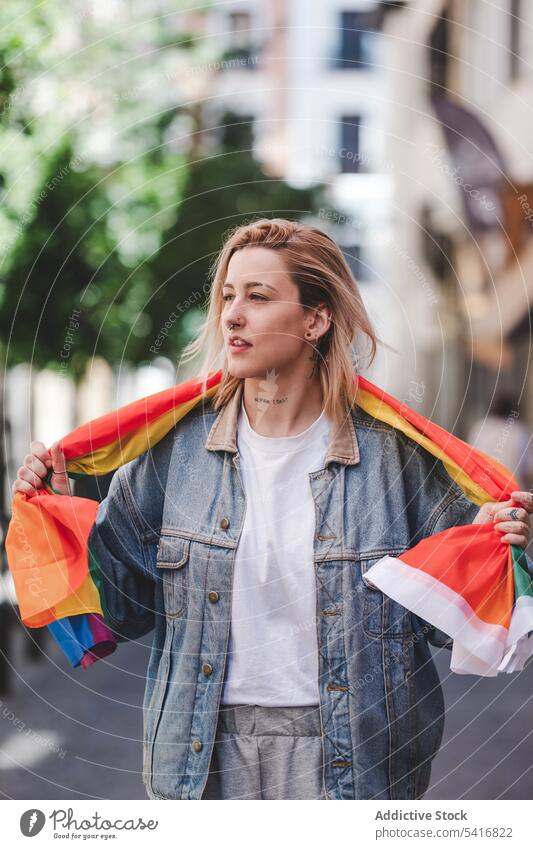 LGBT woman on city street lgbt flag young urban lesbian lifestyle leisure female colorful rainbow rights equality homosexual pride freedom town activist lady