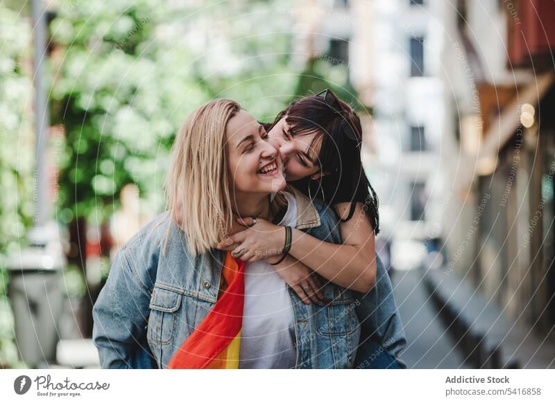 Happy lesbian couple having fun on street lgbt hugging lifting piggyback happy city young together women casual homosexual pride lap equality alternative