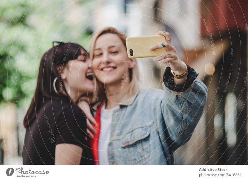 Happy lesbian couple taking selfie on street smartphone lgbt happy city young together women casual homosexual pride equality alternative relationship love