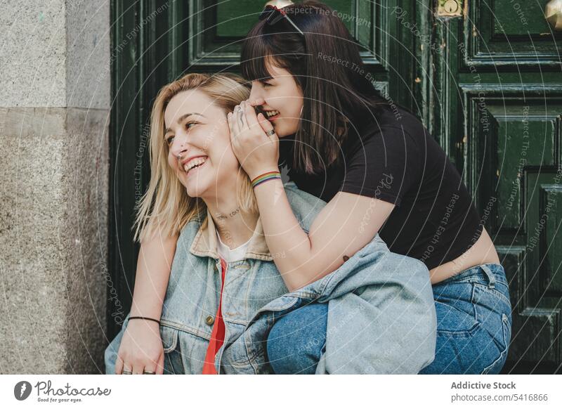 Lesbian couple sitting near door feelings happy smile hugging town beautiful alternative together homosexual women lifestyle relationship leisure relax intimate