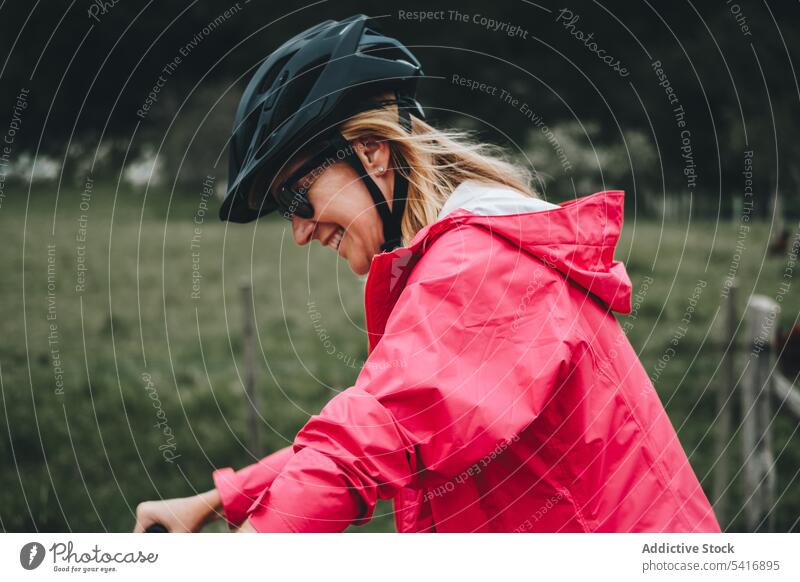 Smiling female riding bicycle woman road young person cheerful active sportive cyclist smiling enjoying lifestyle bike travel transport adventure helmet