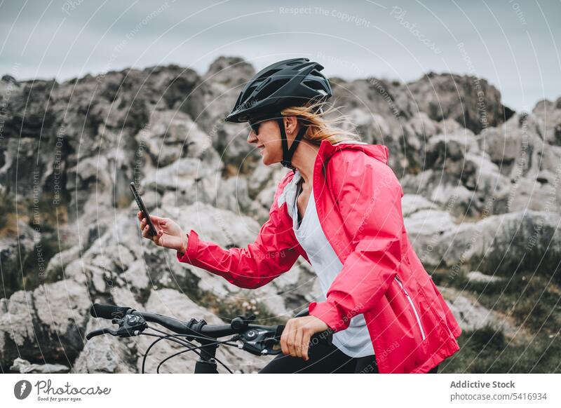Female taking photos on cliffs woman helmet landscape mountain rock travel extreme female adult person active blonde brave sportive contemplating standing