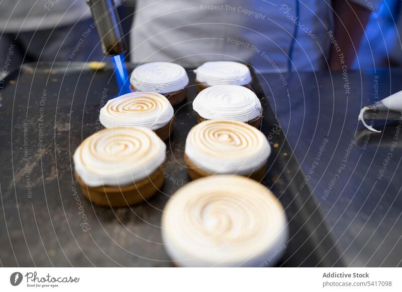 Process of baking meringue cookies whipped cream flame dessert confectionery sweet white food pastry torch sugar tasty delicious fresh gourmet appetizing kiss