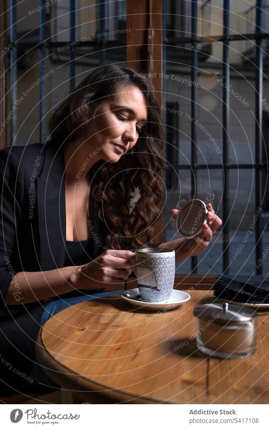 Young female with tea cup in cafe woman making young person attractive brunette beautiful pretty long hair casual relaxed stylish sitting holding strainer lid