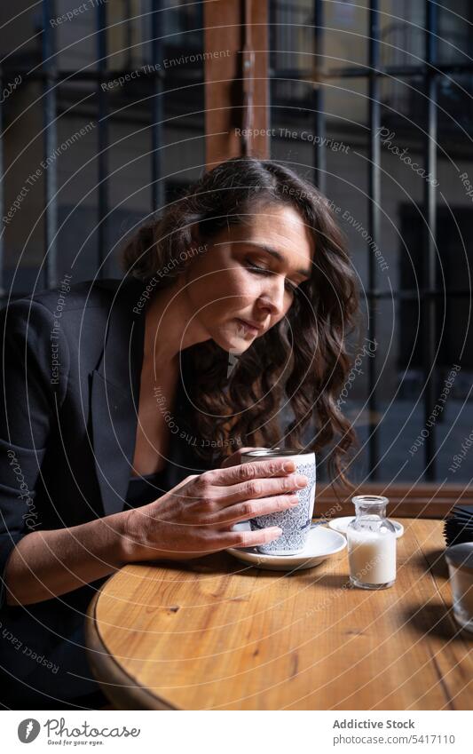 Young female with tea cup in cafe woman making young person attractive brunette beautiful pretty long hair casual relaxed stylish sitting holding strainer lid