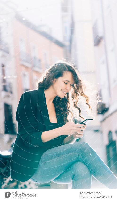Young female walking with smartphone woman mobile sitting talking communication young person attractive brunette beautiful pretty long hair casual relaxed happy