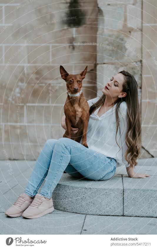 Woman with purebred dog on stone porch woman style street together pet beautiful friend animal dream expression companion love owner mammal pavement canine