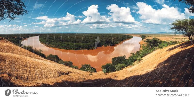 View of dirty river in savanna view omo valley ethiopia africa clouds sky sunny daytime nature landscape stream flow water weather countryside wilderness nobody
