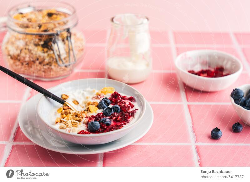Granola, fresh berries and yogurt in a bowl on pink tiles. Breakfast. granola Yoghurt Berries Fresh Food Diet Cereal Delicious Pink Morning Raspberry blueberry