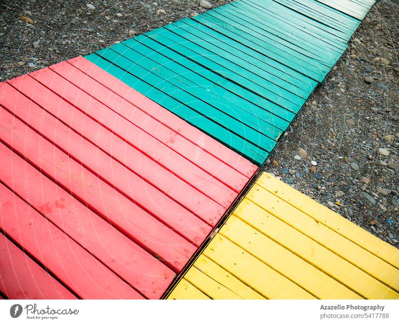 Colorful wooden path on a stony beach. active art beautiful board boardwalk coast colorful environment forward goal ladder landscape lifestyle material