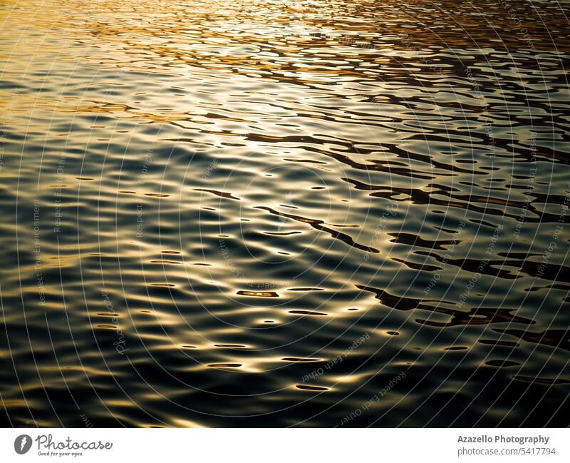 Beautiful sea with warm sunlight reflections during the sunset. abstract aqua background beautiful blue bright calm calmness clean dusk evening gold golden lake