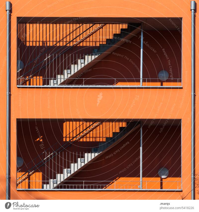 Stairs in orange Orange Facade Building Shadow Architecture Manmade structures Beautiful weather Sunlight Banister Contrast