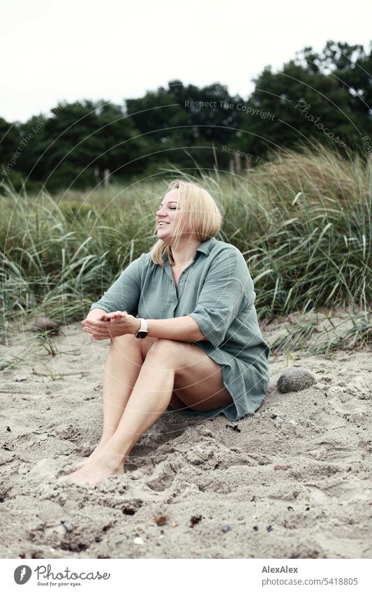 Portrait of beautiful blonde woman sitting in the sand on the beach and happy Woman pretty Blonde Long-haired Blonde hair Joy Smiling Beach Sand Marram grass