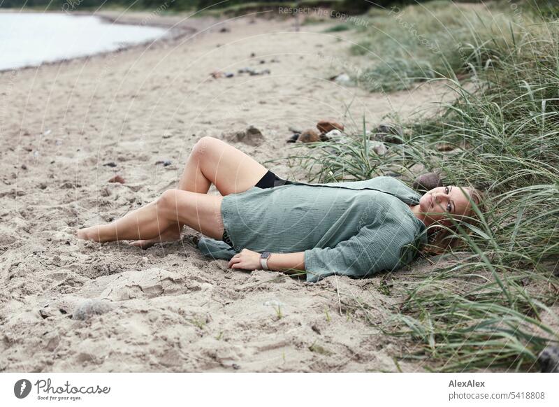 Portrait of beautiful blonde woman lying in sand on beach Woman pretty Blonde Long-haired Blonde hair Joy Smiling Beach Sand Marram grass duene Beauty & Beauty