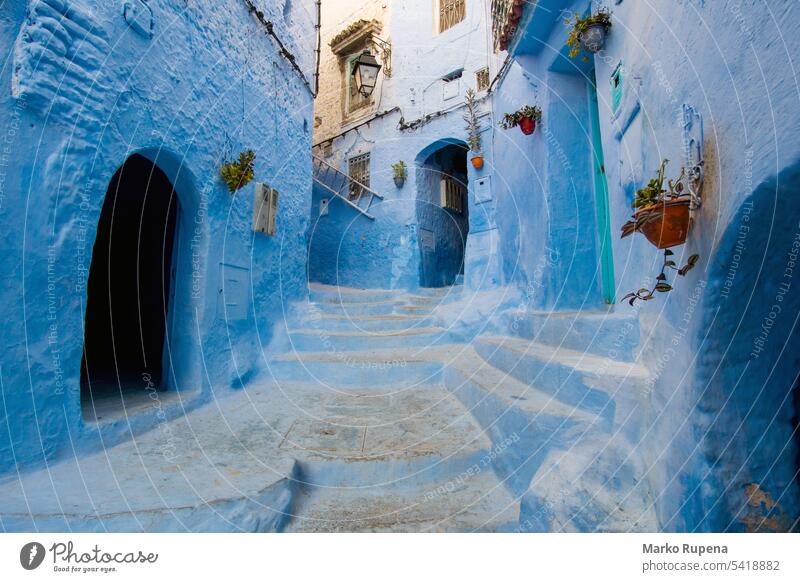 Turquoise narrow street with blue houses and stairway in Chefchaouen in Morocco chefchaouen morocco rustic travel tourism destination city africa architecture