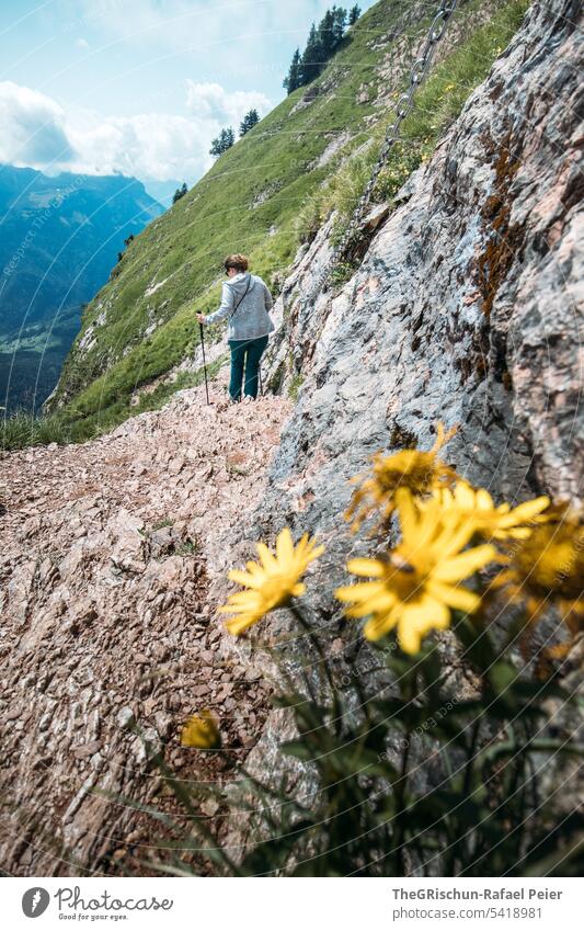 Hike with rocks and flowers in foreground Colour photo big myths Mountain Hiking Switzerland Tourism Lanes & trails Alps Landscape Exterior shot hike Woman