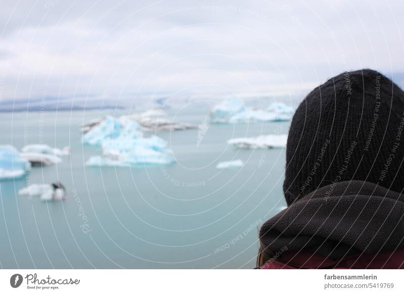 Human head in front of ice lagoon, ice chunks in background glacier lagoon Glacier Iceberg Water chill Cold icily Cap knitted cap Winter Iceland Lagoon Nature