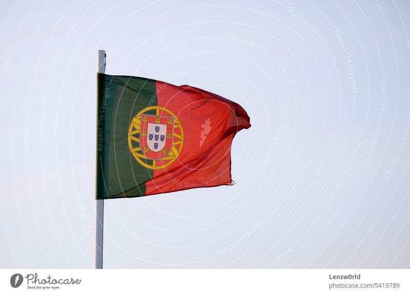 Portuguese flag waving in the wind against a clear sky banner country flagpole government lisbon nation national national flag patriotic patriotism portugal