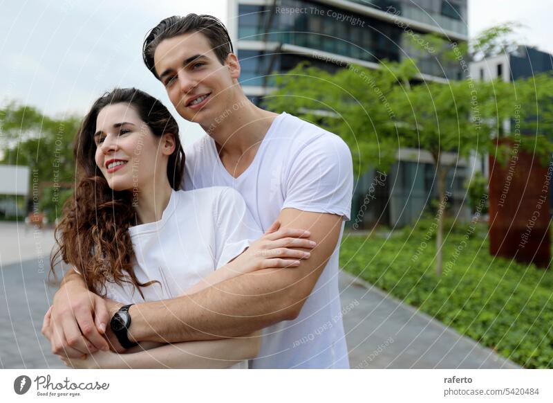 Man and woman couple smiling confident hugging each other at street person love young happy lifestyle together outdoors female human relationships summer