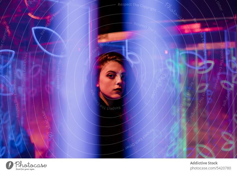 Female teenager in neon light hipster style sign female woman casual posture fashion cool design brunette culture millennial art city street extraordinary