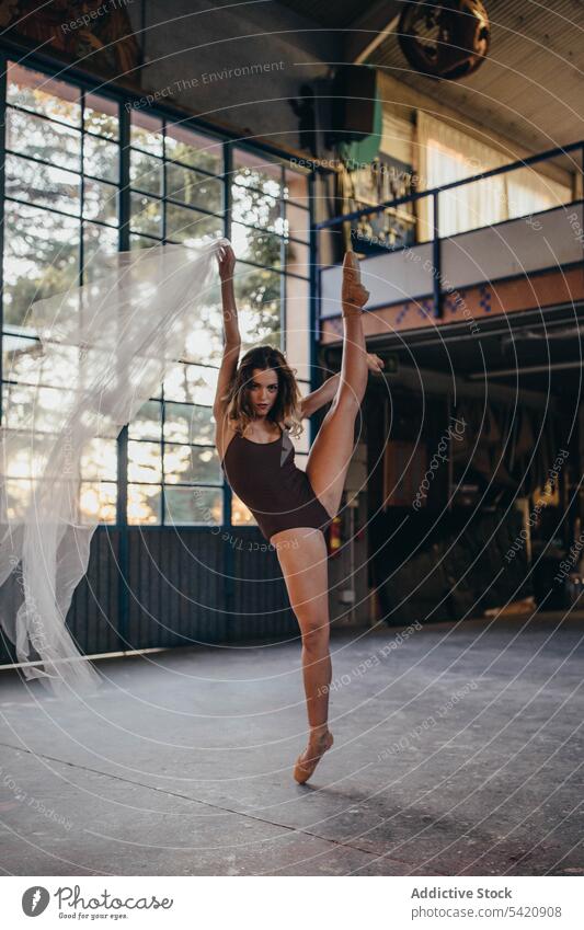 Young woman in bodysuit dancing with veil in studio dance grace light rehearsal romantic ballerina elegant flexible slim choreography alone motion tulle young