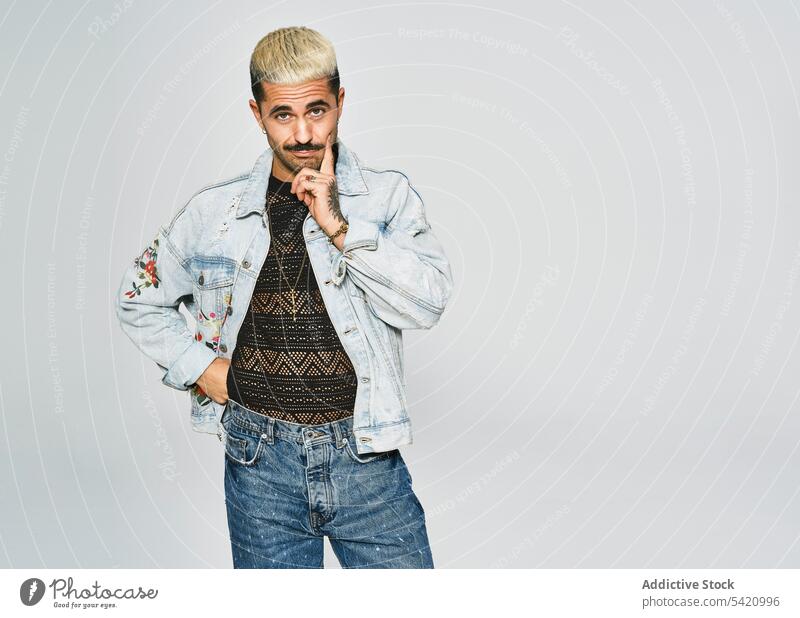 Stylish grimacing man in denim outfit trendy independent expressive grimace style modern hipster ethnic male jacket mustache confident fashion contemporary