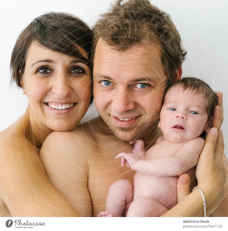 Happy family with newborn baby happy love together embrace smile relationship portrait mother father positive young child hug kid cuddle dad mom parent cheerful