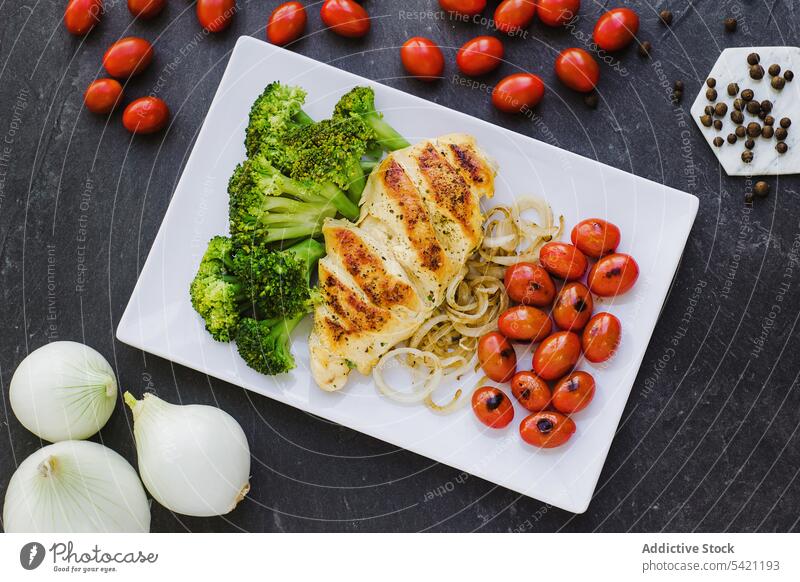 Chicken and broccoli with onions and tomatoes dish plate chicken vegetable serve pepper cherry fried delicious food kitchen spice roast dinner healthy meal