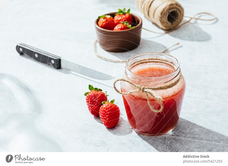 Healthy strawberry drink in glass jar juice homemade rustic fresh natural healthy twine knife tasty ripe delicious food vitamin ingredient nutrition appetizing