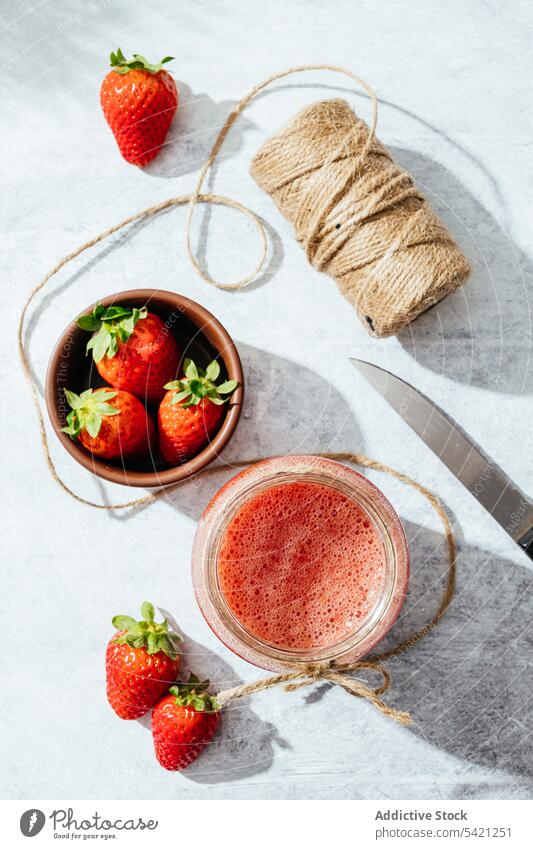 Healthy strawberry drink in glass jar juice homemade rustic rope fresh natural healthy twine knife tasty ripe delicious food vitamin ingredient nutrition