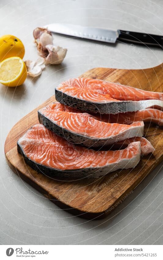 Fresh fish steaks on wooden board salmon fresh food raw slice cutting board recipe healthy ingredient delicious seafood kitchen cook dish meal piece cuisine