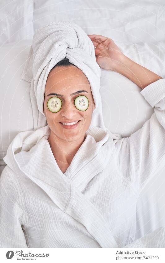 Young woman with cucumber mask on eyes beauty skin care positive enjoy spa facial natural young female smile happy cheerful fresh clean cosmetology therapy