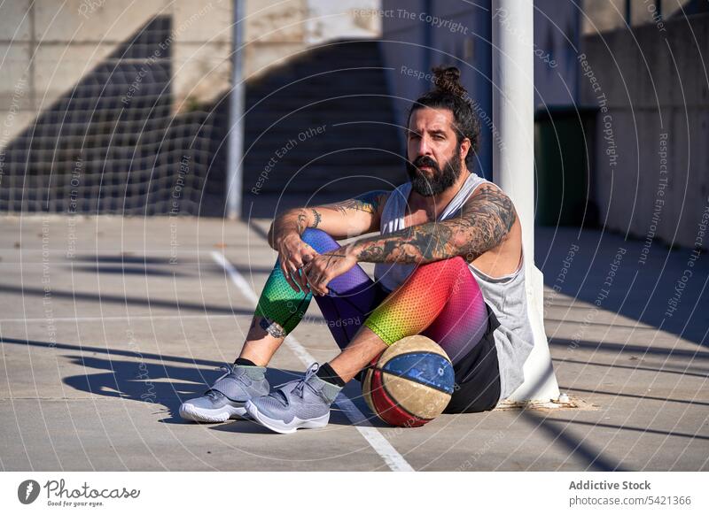 Man with a beard playing basketball on an urban court competition energy athlete street city training action game player score sport outdoor activity exercise